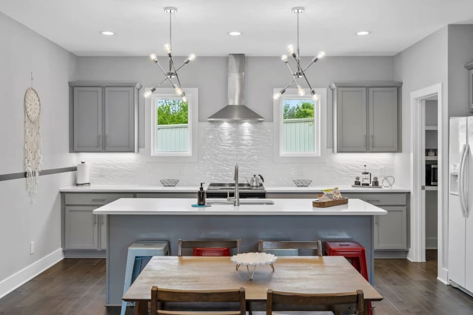 Another view of the open kitchen, highlighting the ample counter space and bar seating that keeps the cook connected to the party.