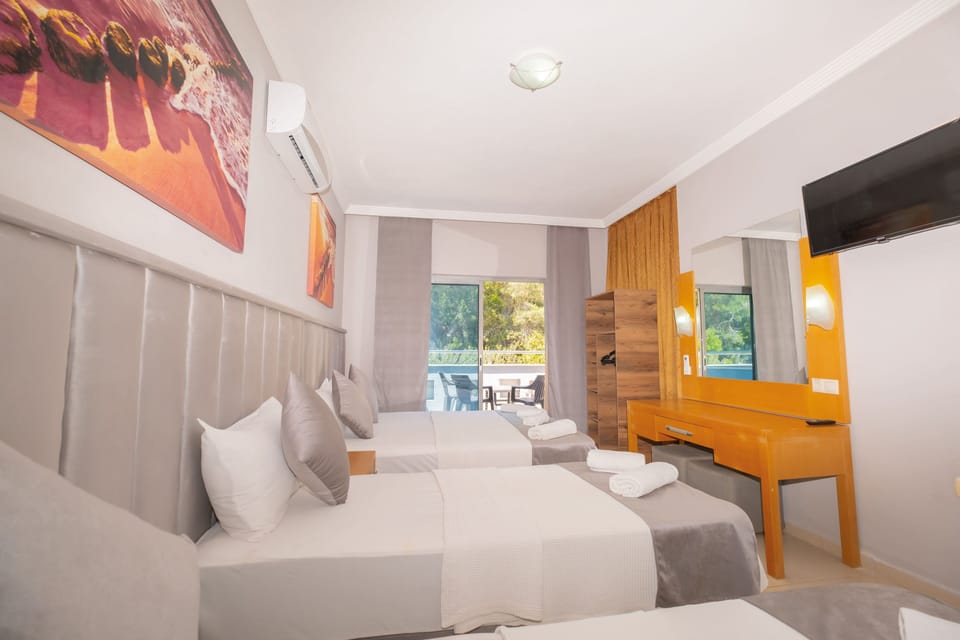 Deluxe Quadruple Room | Premium bedding, in-room safe, soundproofing, iron/ironing board