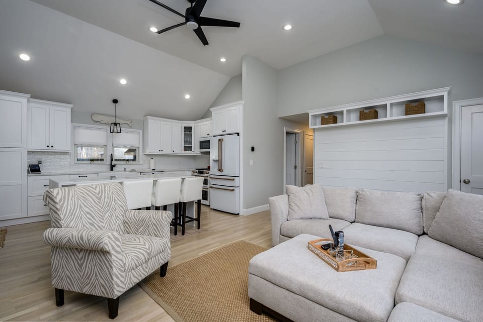 Read a book in the comfortable chair by the fireplace - 176 Sudbury Lane Hyannis Cape Cod - Family Tides - NEVR