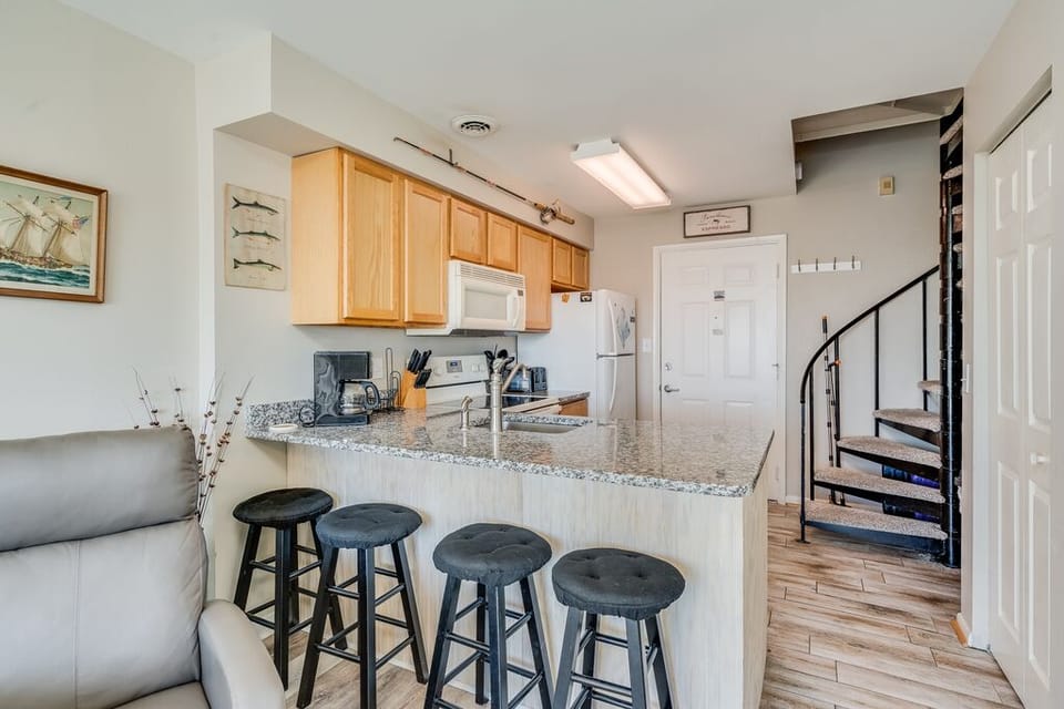 Wide open first floor living space is perfect for relaxing after after a day at the beach or pool