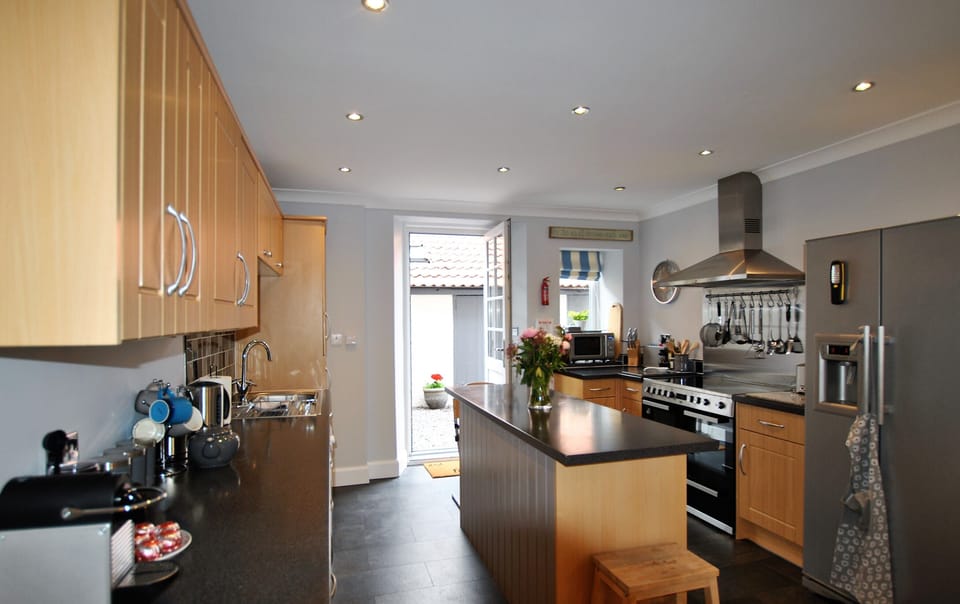 The kitchen opens onto the outdoor areas