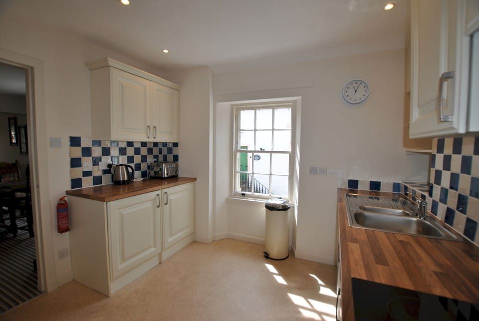 The kitchen is located next to the open-plan dining area and lounge