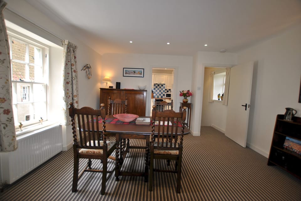 The upper-level flows from the kitchen through the dining area to the lounge
