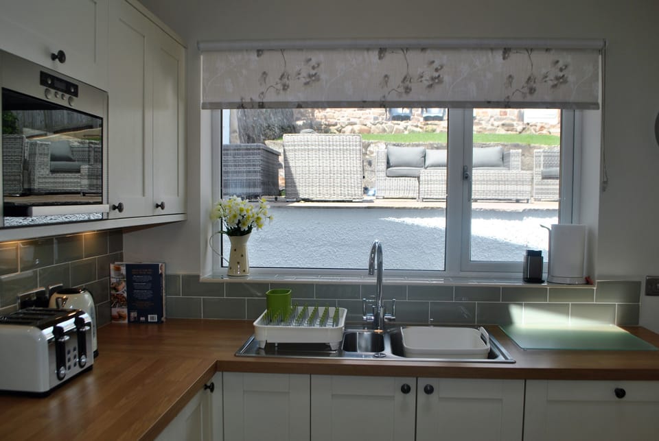 The kitchen opens out onto the garden