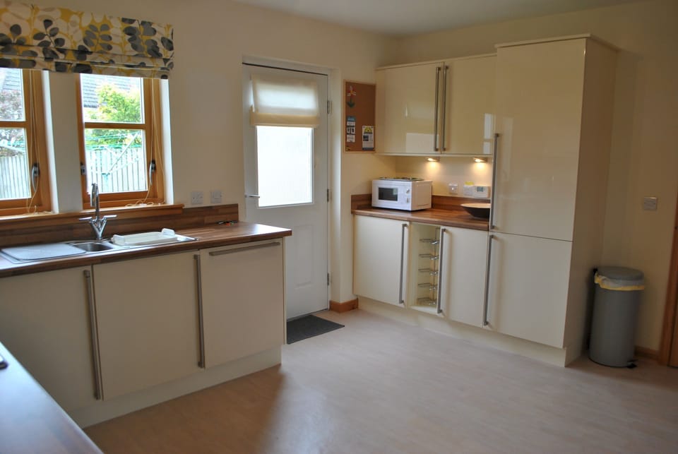 The kitchen offers access onto the enclosed garden