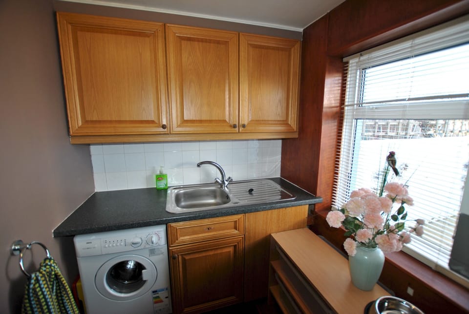 A useful utility room leads to access to the garden.