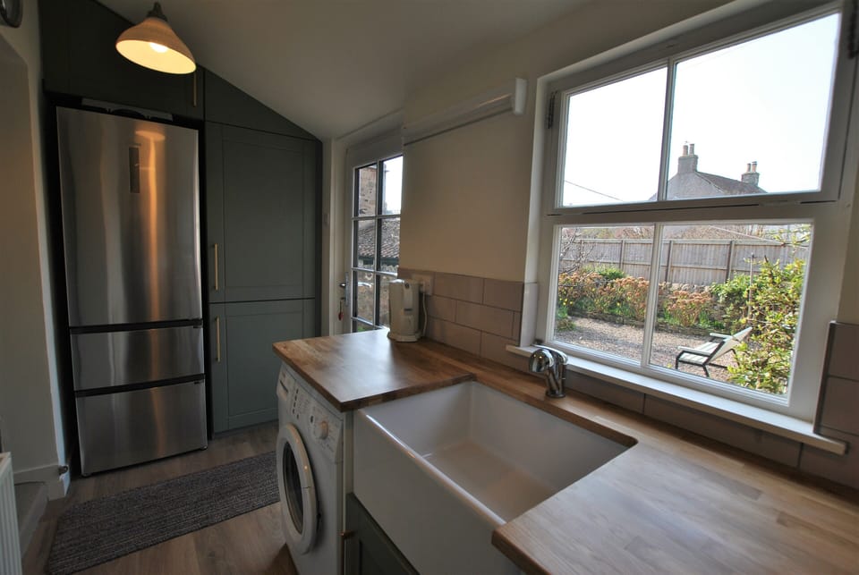 The utility room offers access to the garden as well as useful additional facilities