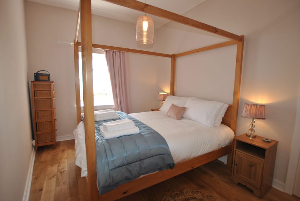 The bedroom is light and bright with muted tones for complete relaxation