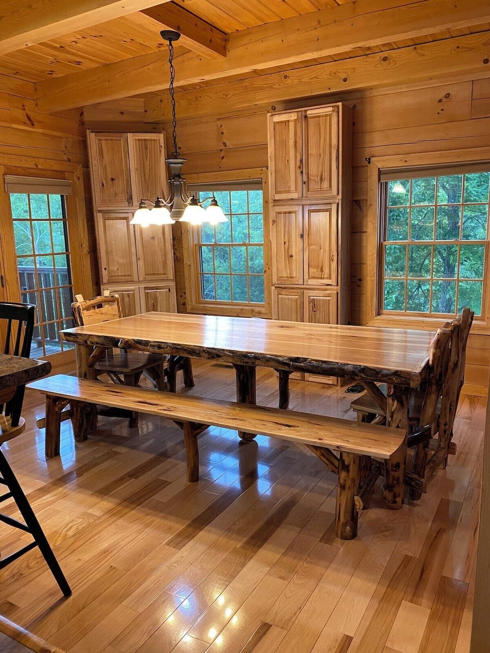 The Dining area has a huge 9 foot table with lots of room for large groups to eat at the table, the counter with highback chairs, a pull-up coffee table in the living room, and a large table on the front porch. There are also more tables on the patios.