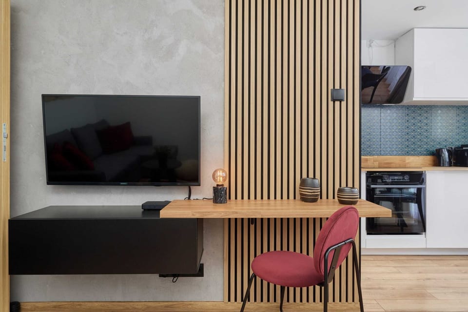 A modern TV unit with a slatted wooden wall accent, adding sophistication to the space.
