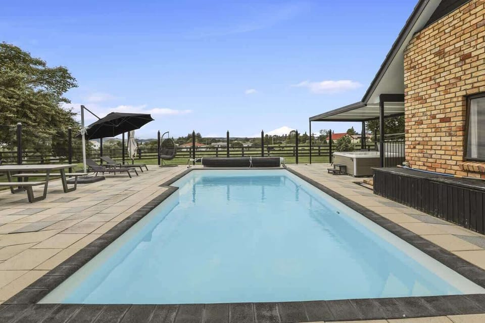 Umbrellas, picnic tables and space to spread out beside the pool.