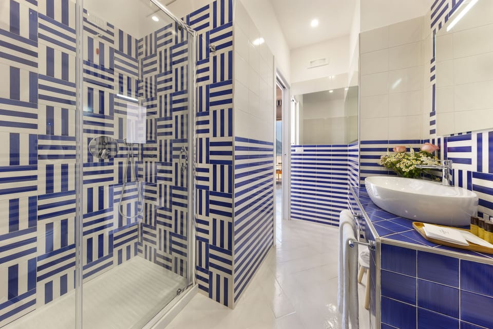 Deluxe Room, Ground Floor | Bathroom | Shower, rainfall showerhead, hair dryer, bathrobes