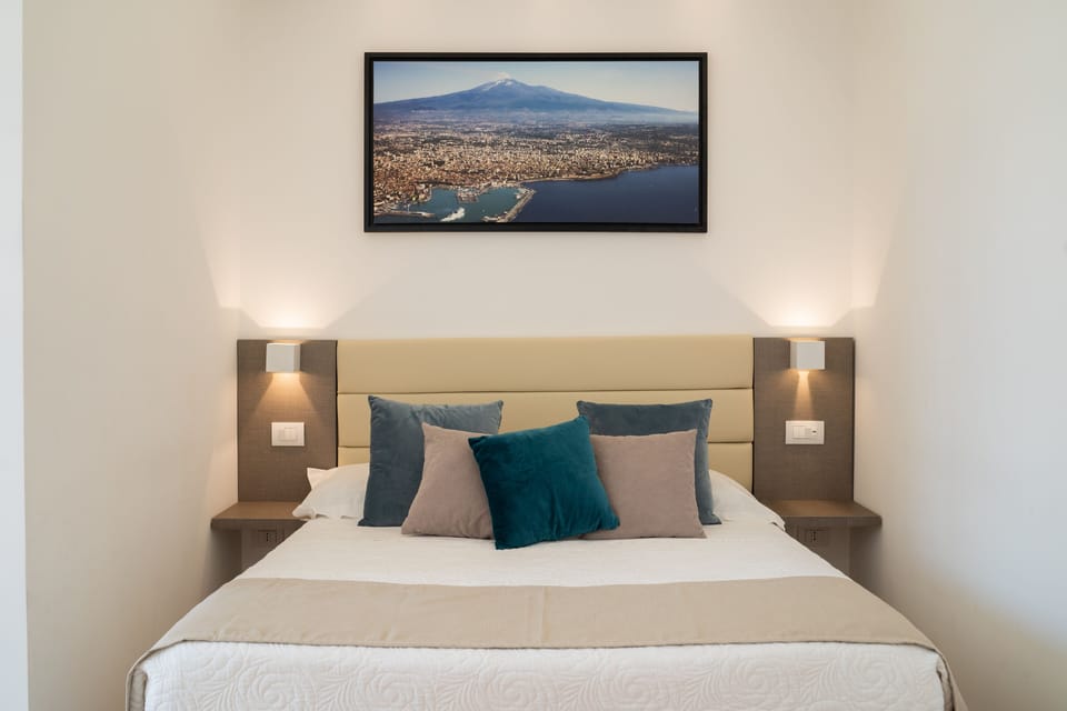 Deluxe Quadruple Room | Minibar, in-room safe, desk, laptop workspace