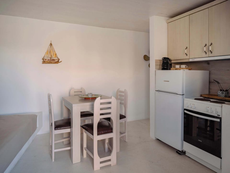 Fully equipped kitchen and cozy dining area for home-cooked meals with a view.