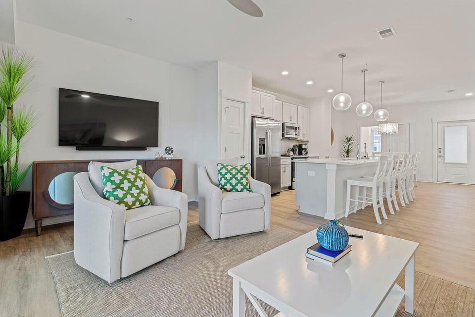 Deluxe Townhome | Living area | 27-inch Smart TV with cable channels, TV, streaming services