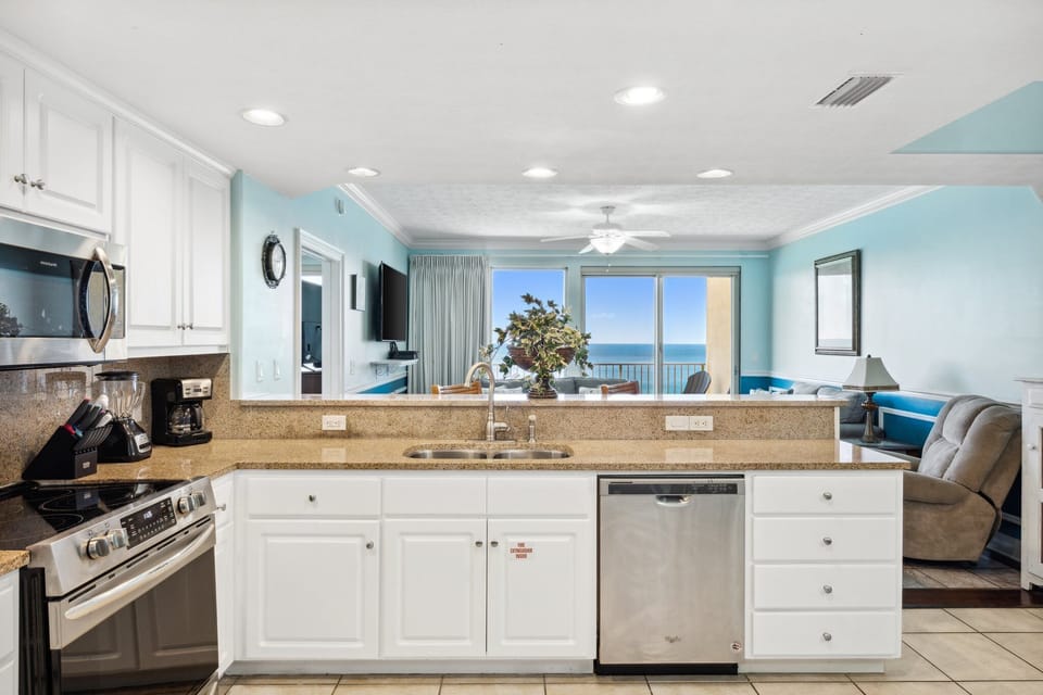 Bright kitchen w/ a spacious island, perfect for prepping meals while staying connected to the group