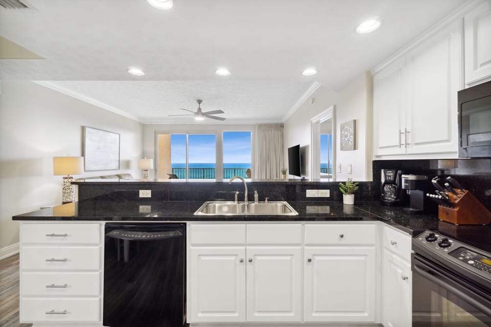 Modern kitchen with ocean views visible from the living area.