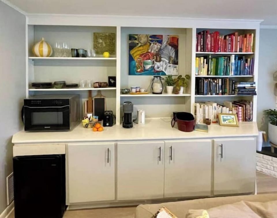 Mini-fridge, Nespresso, toaster, kettle, microwave, dishes, utensils. 