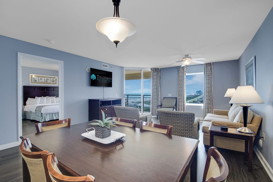 Relax in your spacious suite with ocean views, comfortable seating, and elegant touches throughout your coastal retreat.