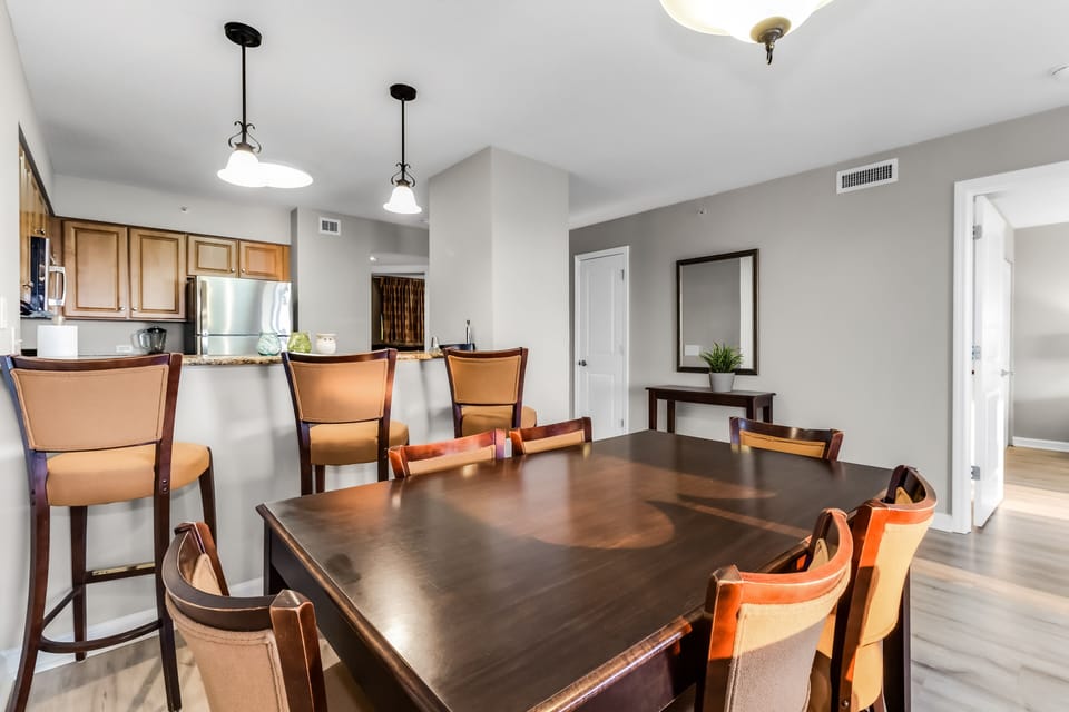Gather around your elegant dining table for memorable meals in this open-concept space that flows seamlessly into your modern kitchen.
