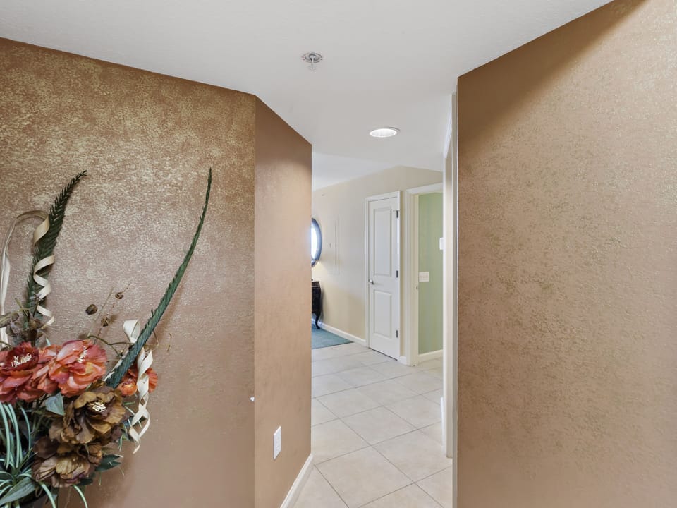Step into your welcoming hallway with warm earth tones and stylish tile flooring that flows throughout your space.