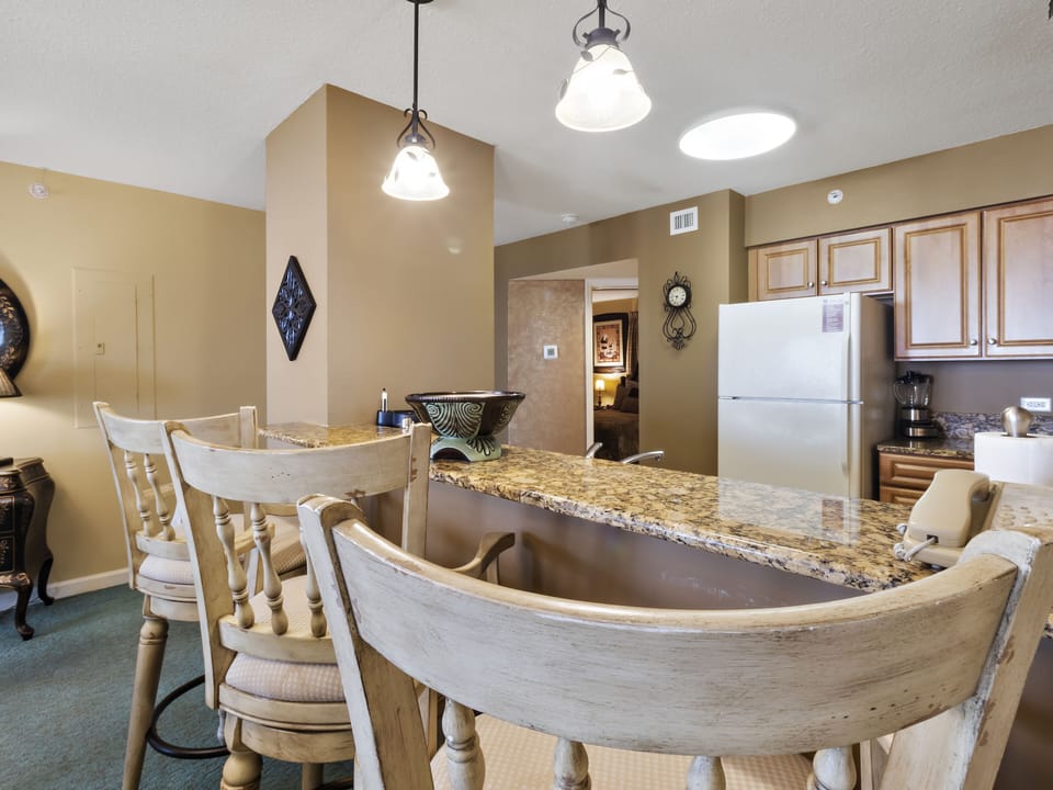 Your spacious kitchen features granite counters, breakfast bar seating, and modern appliances for memorable vacation meals together.