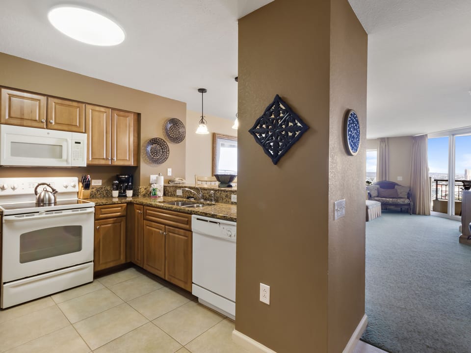 Your fully equipped kitchen flows into a bright living space with city views from your private balcony.