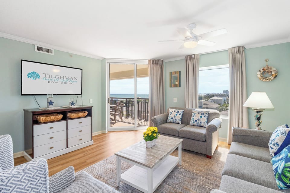 Relax in your spacious living room with coastal decor and enjoy stunning views from your private balcony.