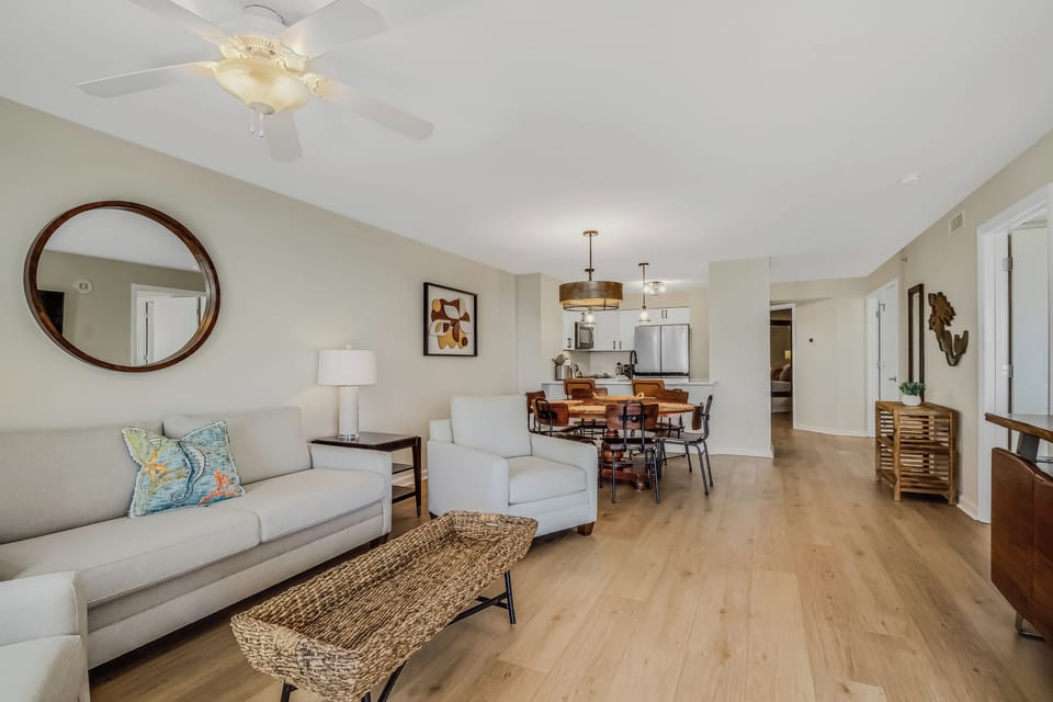 Relax in your spacious open-plan living area with comfortable seating and warm wood floors that flow seamlessly to your dining space.