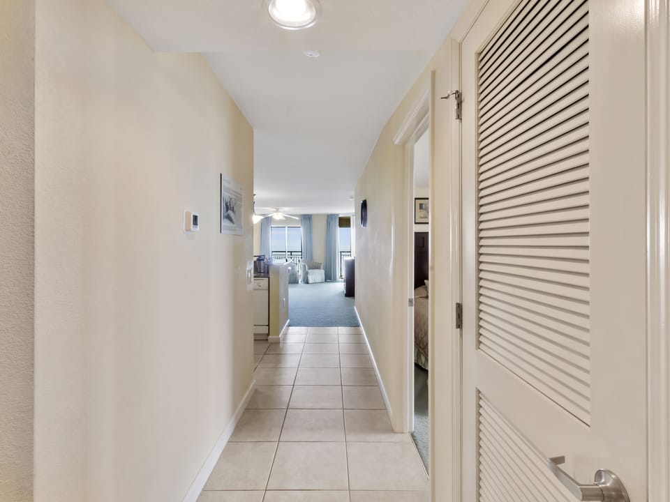 Your private hallway leads to the bright living space, with convenient storage keeping everything organized during your stay.