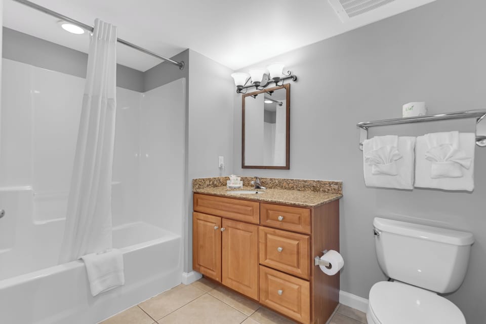 Step into your pristine bathroom with granite counters, fresh towels, and everything you need for a comfortable stay.