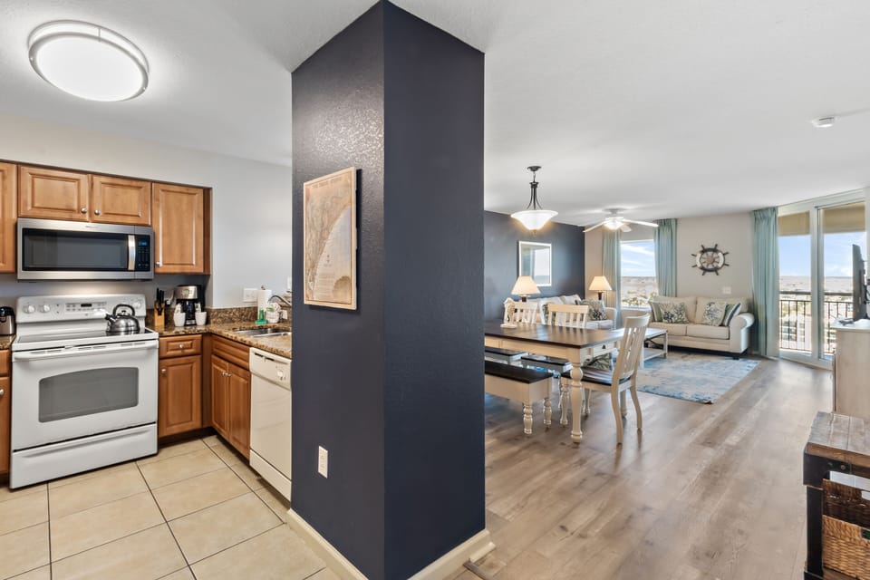 Your spacious open-plan home blends modern comfort with coastal charm, featuring a fully equipped kitchen, elegant dining space, and cozy living room.