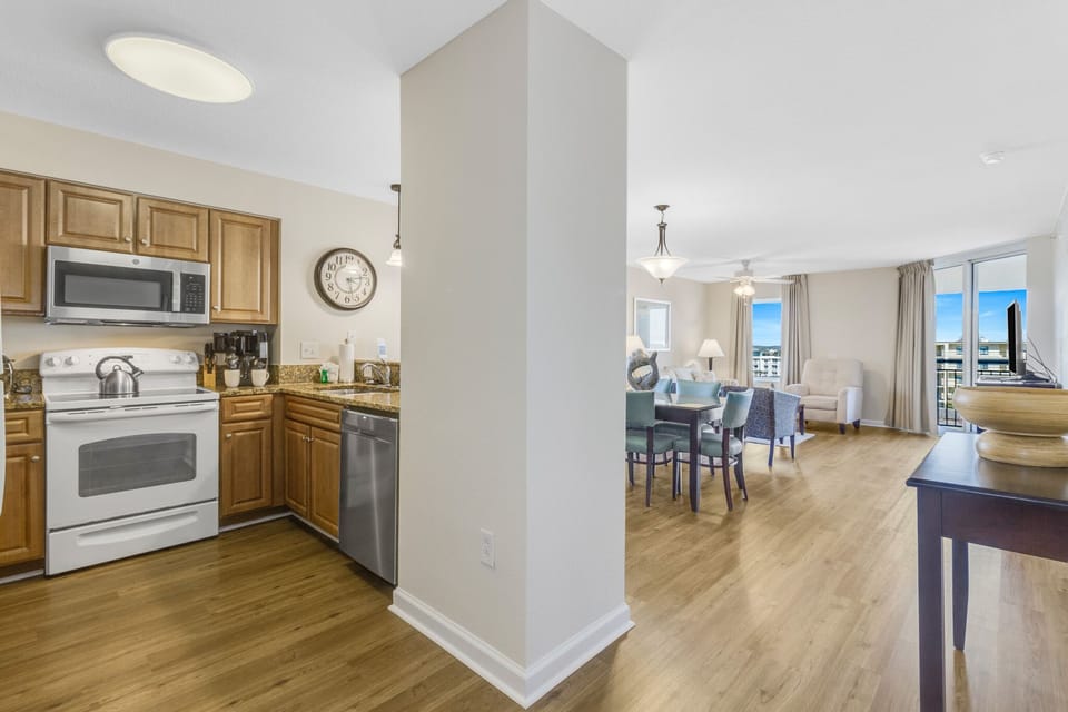 Your open-concept haven awaits with a fully equipped kitchen flowing into bright living space, perfect for home-cooked meals and city views.