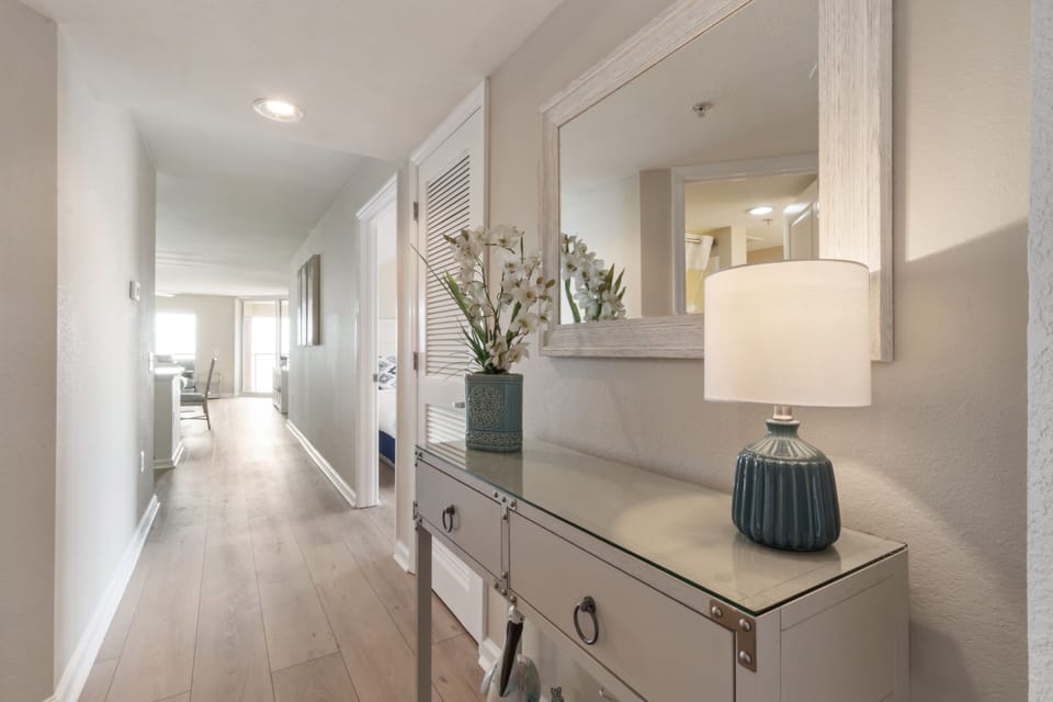 You'll love coming home to this bright, welcoming hallway with stylish decor and warm lighting that leads to your comfortable living spaces.
