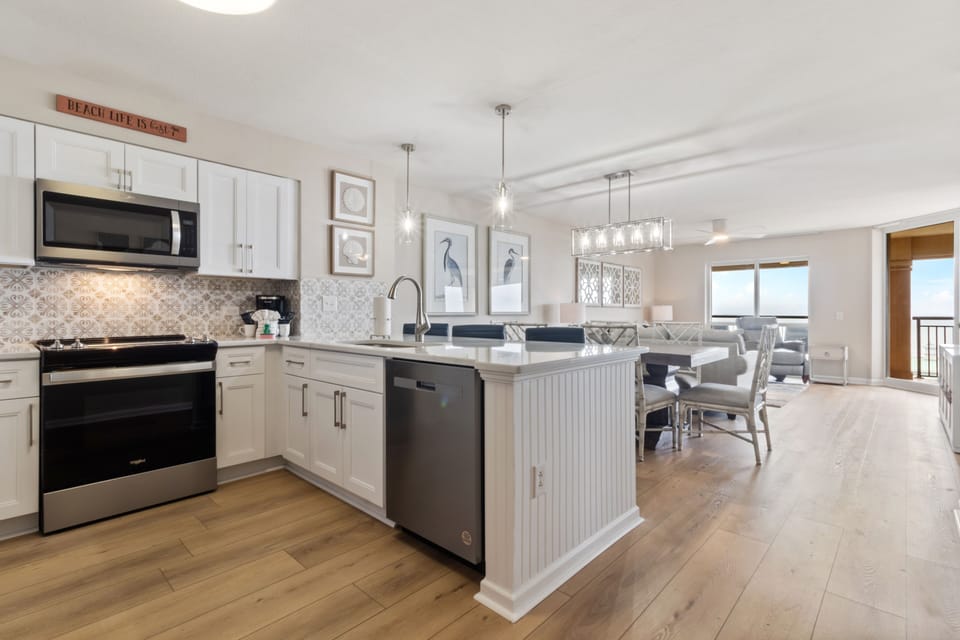 Your fully equipped kitchen features modern appliances and a spacious island, perfect for preparing meals while enjoying ocean breezes.