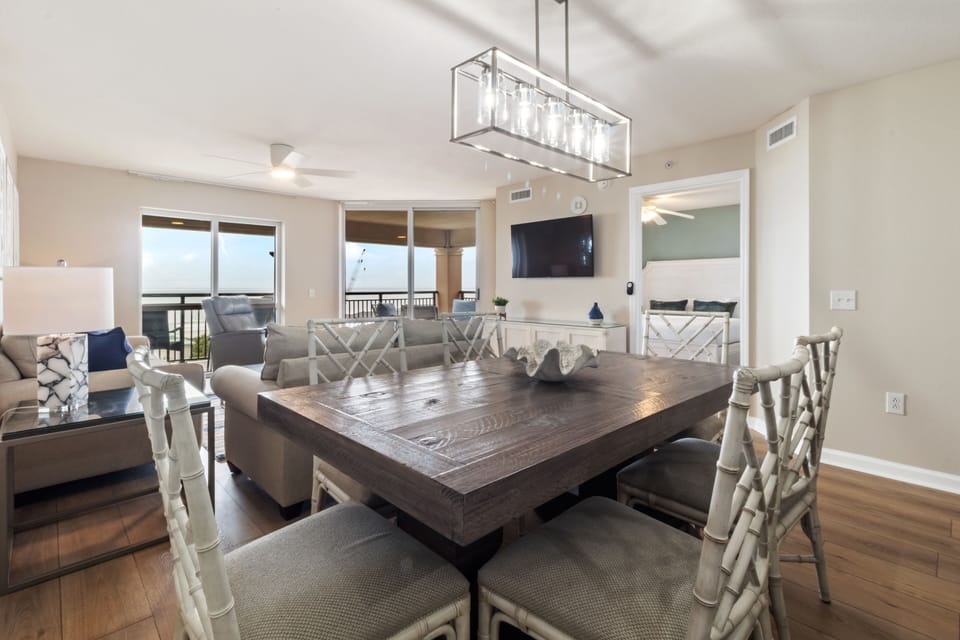Gather around your elegant dining table while soaking in beautiful natural light from the sliding doors.