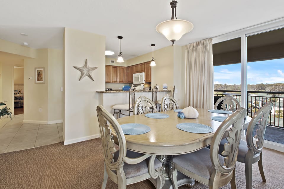 Gather around this elegant dining table for memorable meals while enjoying stunning views through floor-to-ceiling windows.