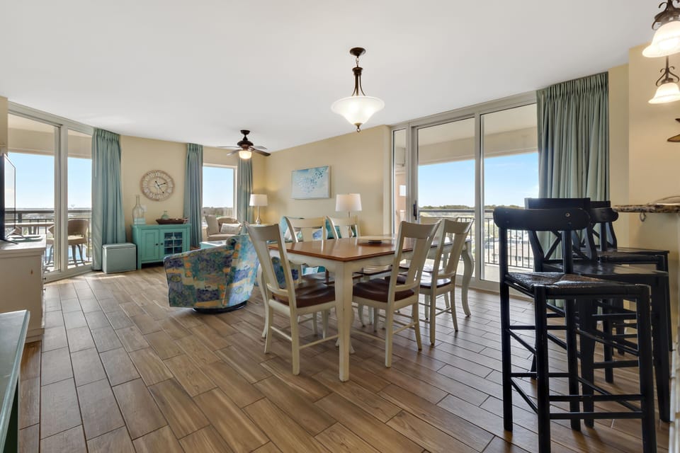 Your spacious open living area flows seamlessly from dining to relaxation, bathed in natural light from floor-to-ceiling windows.
