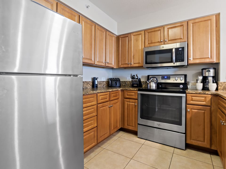 Your fully equipped kitchen awaits with stainless steel appliances, granite counters, and warm wood cabinetry for memorable meal prep.