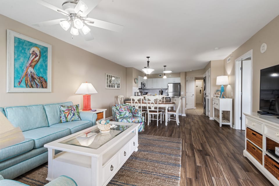 Your open-concept living space invites relaxation with coastal décor, comfy seating, and a fully equipped kitchen for memorable meals together.