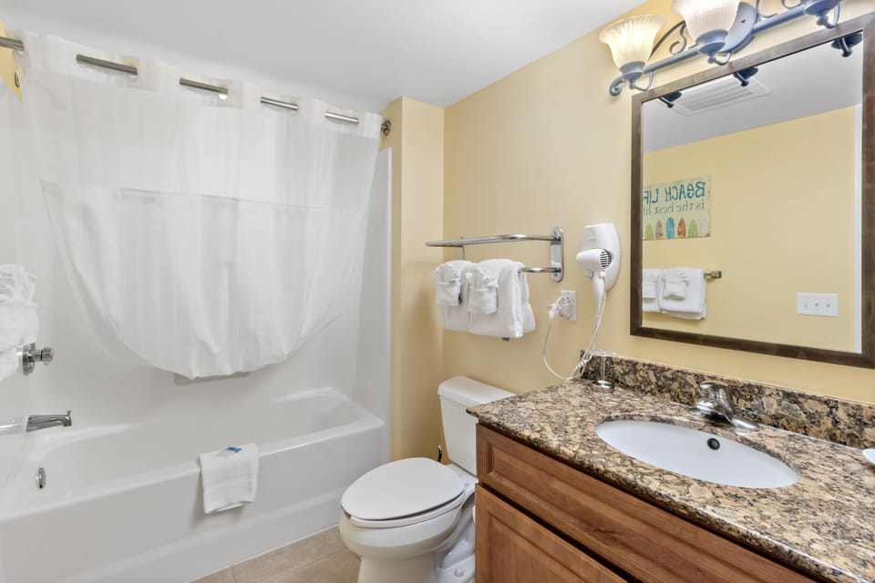 Refresh after your adventures in this well-appointed bathroom featuring granite counters, modern fixtures, and fresh towels.