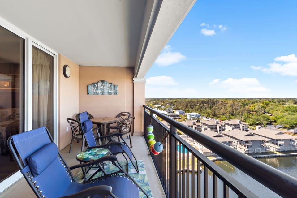 Relax on your private balcony with panoramic views of the marina and lush waterfront landscape stretching to the horizon.