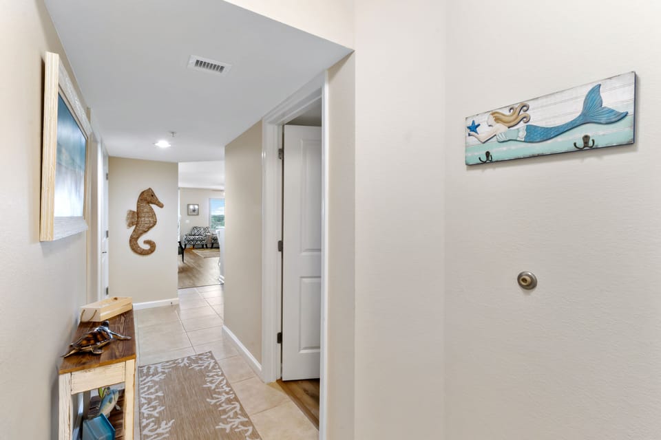 Your private hallway welcomes you with charming coastal touches and thoughtful hooks for your beach gear and towels.