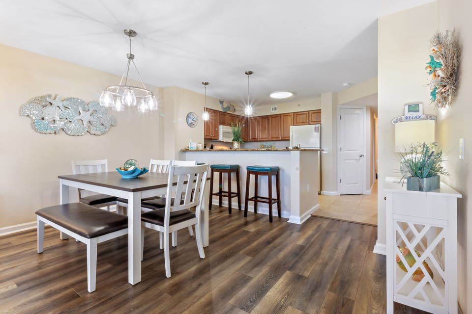 You'll love this open kitchen and dining space with coastal charm, featuring bar seating and a dining table perfect for memorable meals together.