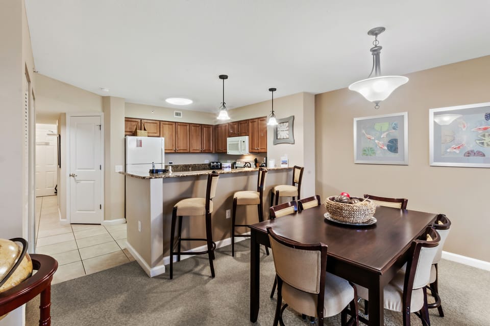Your open-concept kitchen and dining space features warm wood cabinetry, granite counters, and elegant seating for memorable meals together.