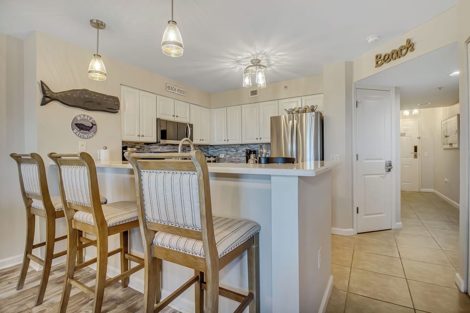Your spacious kitchen island seats four comfortably, perfect for morning coffee or casual dining with coastal charm.