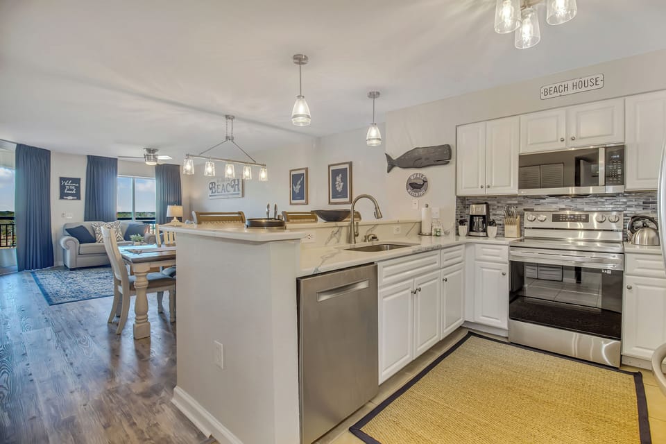 Your fully equipped kitchen flows seamlessly into the dining and living area, perfect for preparing meals while staying connected with family.