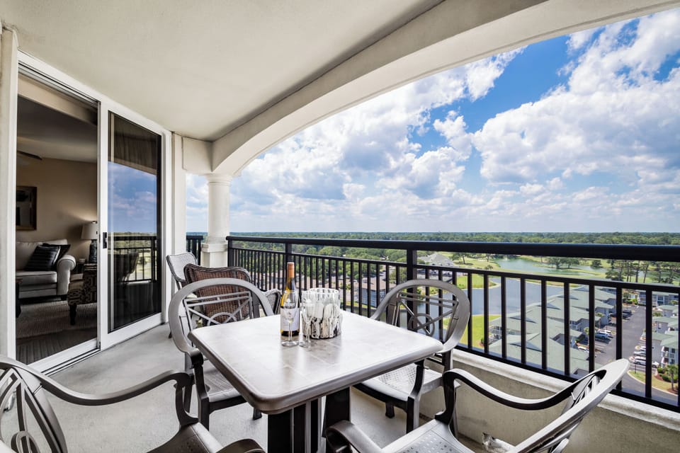 Dine al fresco on your private balcony with stunning views stretching across lush green landscapes and endless skies.