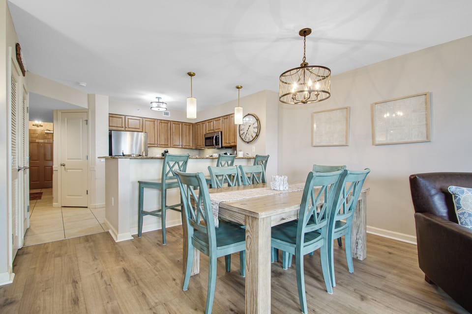 Gather around your elegant dining table for memorable meals, with a fully-equipped kitchen and stylish pendant lighting creating the perfect ambiance.