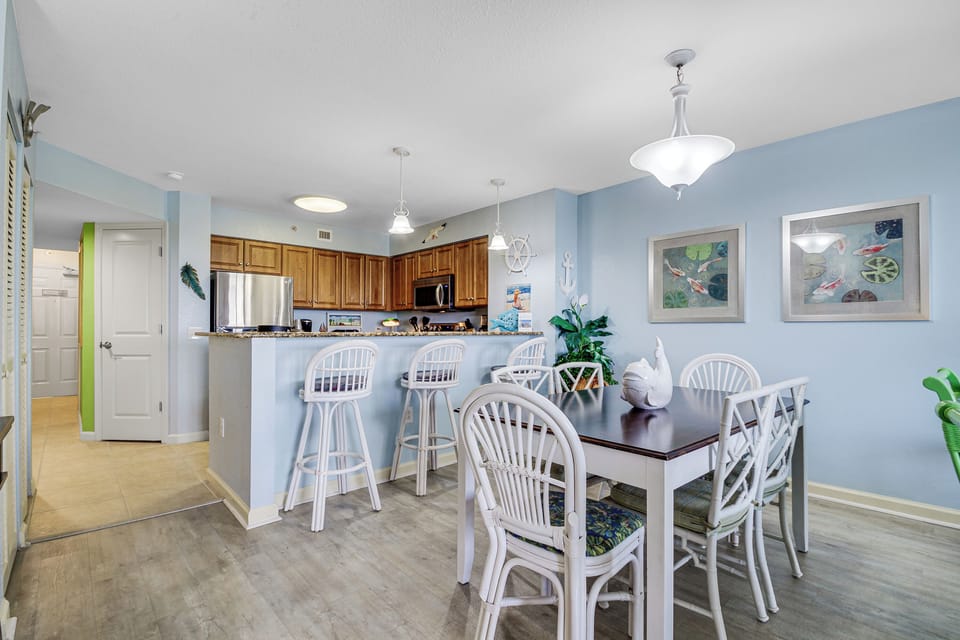 Your bright, coastal-inspired dining space flows seamlessly into the modern kitchen, perfect for family meals and morning coffee.